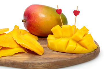 Fresh and dry mango slices on a wooden Board