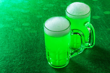 Celebrating St. Patrcik's Day. St.Patrick's Day green beer on the green background. Traditional irish holiday.