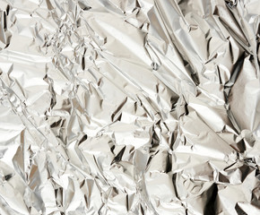 texture of matte crumpled piece of foil, food and objects packaging material, close up