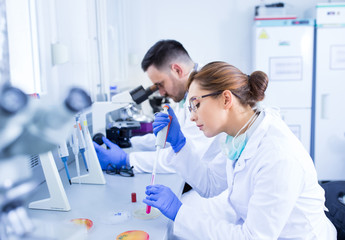 Biologists working on samples in laboratory