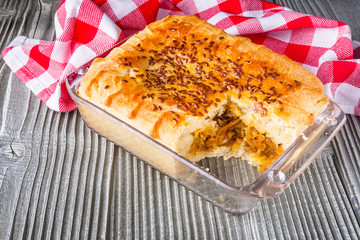freshly baked cabbage pie on rustic wooden background