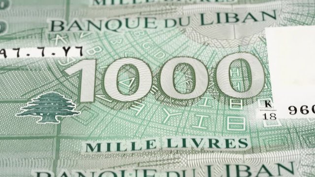Lebanese 1000 pound notes tracking, fast moving. Slider shot. Low angle, macro. 4K