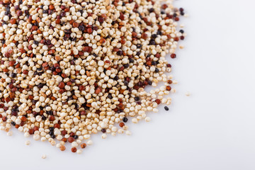 mix of quinoa grains on white acrylic background