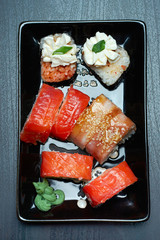 rolls and sushi on a black plate.traditional Japanese dish.the view from the top