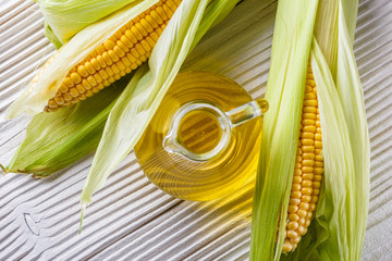 corn oil on white wooden rustic background