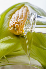 corn oil on white wooden rustic background