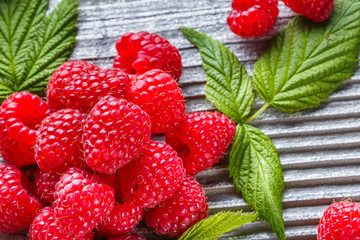 juicy fresh natural raspberries on a gray wooden rustic background