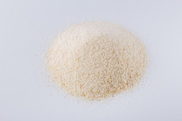 natural organic semolina on white acrylic background