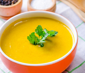 Pumpkin soup served on the table in bowl