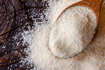 natural organic semolina on dark wooden rustic background