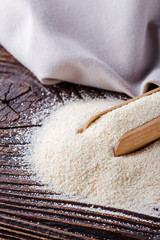 natural organic semolina on dark wooden rustic background