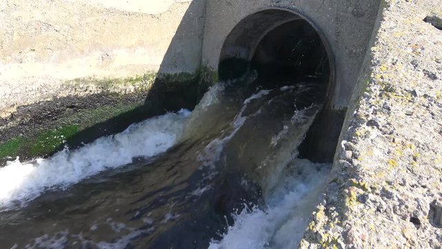 Water pollution. Dirty water from treatment plants flows through a pipe into a closed estuary or lake. Ecology of the sea, kills animals. Ukraine