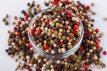 mix of peppercorns on white acrylic background