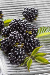juicy blackberries on gray wooden rustic background