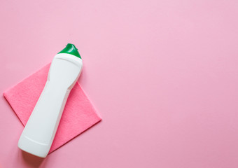 House cleaning and housekeeping concept. Cleaning supplies on pink  background. Cleaner detergent bottle, rag, sponge, rubber gloves. Top view and copy space Flat Lay 