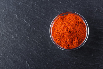 aromatic ground paprika on a dark stone background