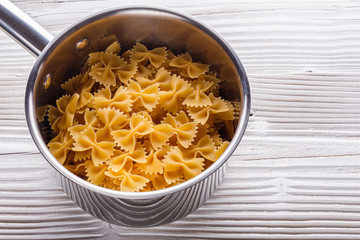 traditional italian pasta in a metal pan on a wooden background