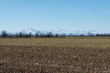 Farming landscape with the wonderful Alps mountains in the background in northern Italy just...