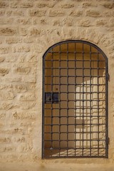 Closed iron lattice forged doors in the wall of the fortress Ribat, Monastir