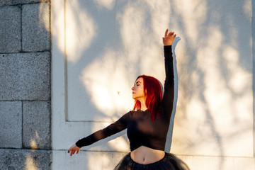 Redhead dancer dancing ballet in the Retiro park in Madrid