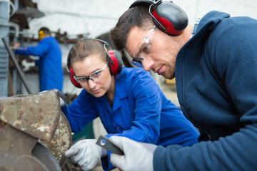 man and woman work in motor manufacturing factory