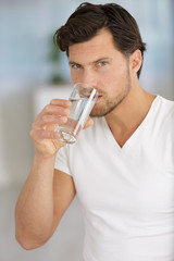 Fototapeta na wymiar man drinking water from a glass