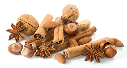 isolated image of anise, walnuts, cinnamon sticks on white background close-up