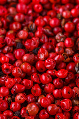 fragrant pink peppercorns on white acrylic background