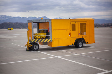 Special vehicles on the runway. Loader at the airport. A special machine for moving an airplane. Security at the airport is ensured by appliances.
