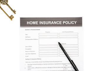 Home insurance policy document near a pen and keys