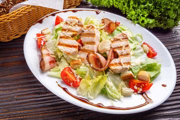 Caesar salad on dark wooden rustic background
