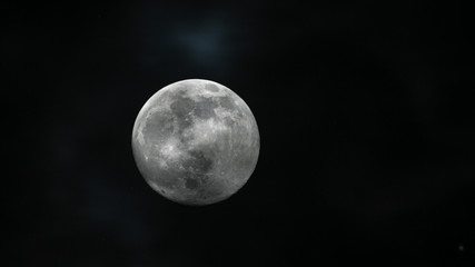 the moon is bright in the dark sky.