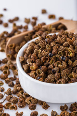 fragrant Sichuan pepper on white acrylic background