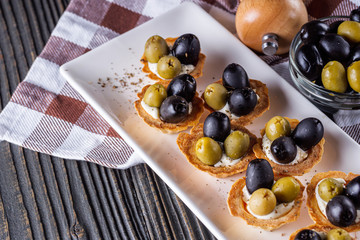 delicious snack tartlets on rustic wooden background