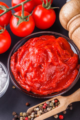 fresh natural tomato paste on black background
