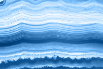 Abstract background - striped agate slice mineral, color of the year 2020 pantone classic blue...