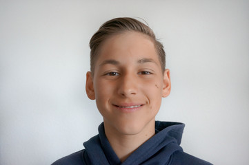Portrait of smiling teenage boy with skin imperfection wearing sport hoodie