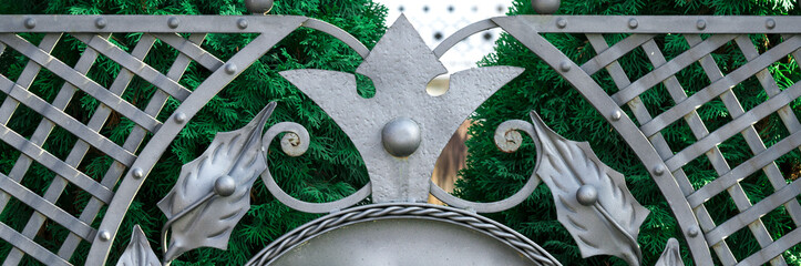 .Forged gate with leaves closeup