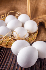 white chicken eggs on wooden rustic background