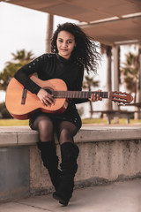Fototapeta na wymiar Brunette girl playing classical guitar