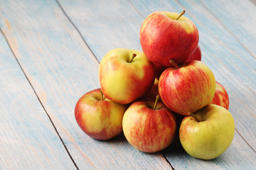 Several ripe red apples on the wooden table	