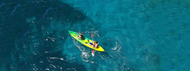 Aerial drone ultra wide photo of couple practising sport kayak in tropical exotic bay with emerald...