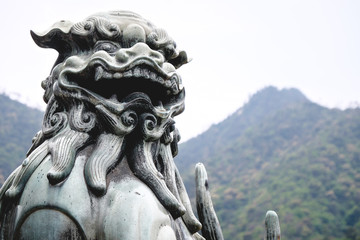 Old and traditional lion stone statue, Miyajima, Japan