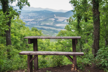 old wooden bench and table in a mountain forest