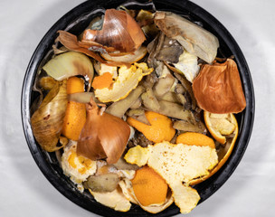 Organic biological kitchen waste, compostable food scraps, rotten food and leftovers from cooking, prepared for composting, Onion peel, Potato peel, Carrot husks, Orange peel