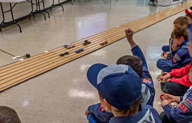 Excited cub scout boys at pinewood derby car race - obrazy, fototapety, plakaty