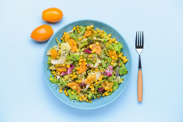 Bowl with tasty salad on color background
