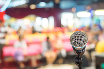 Microphone over the Abstract blurred of speech in seminar room or conference hall light in exhibition center background, business and education concept.