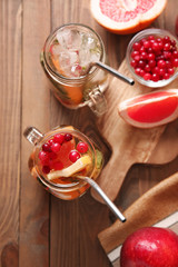 Mason jars of cold tea on wooden table