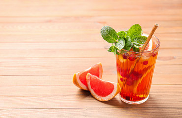 Glass of cold tea on wooden table